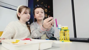 Dziewczynki budują robota z klocków Lego –